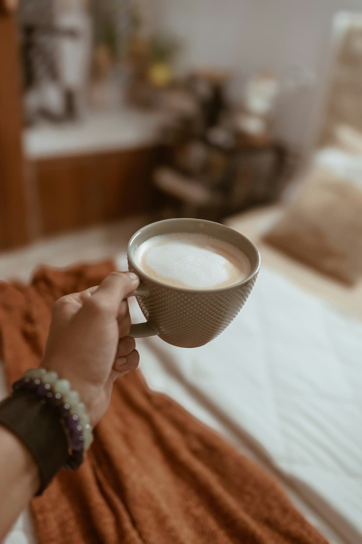 A person holding a cup of coffee at home