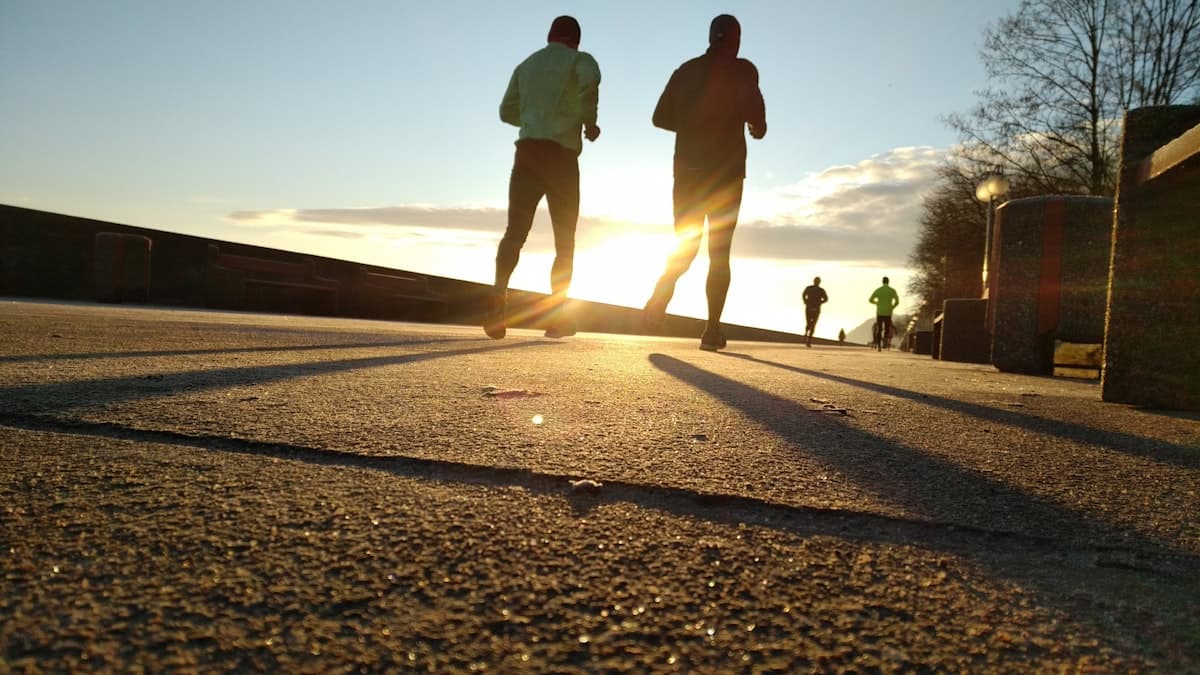 Two people jogging outdoors in the early morning